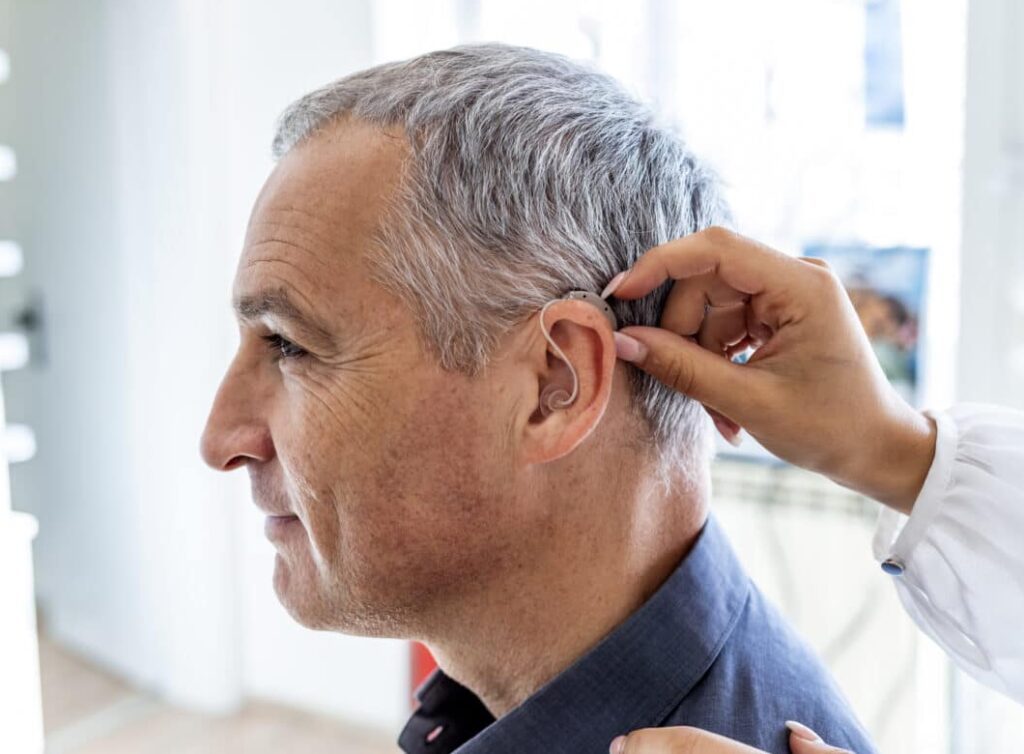 Man Being Fit For A Hearing Aid 1280x853 1 E1774370736436 1024x754
