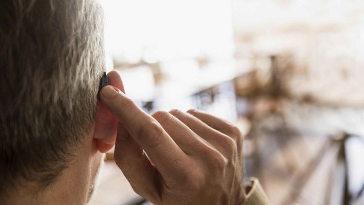 man with hearing aid from behind1920x1080